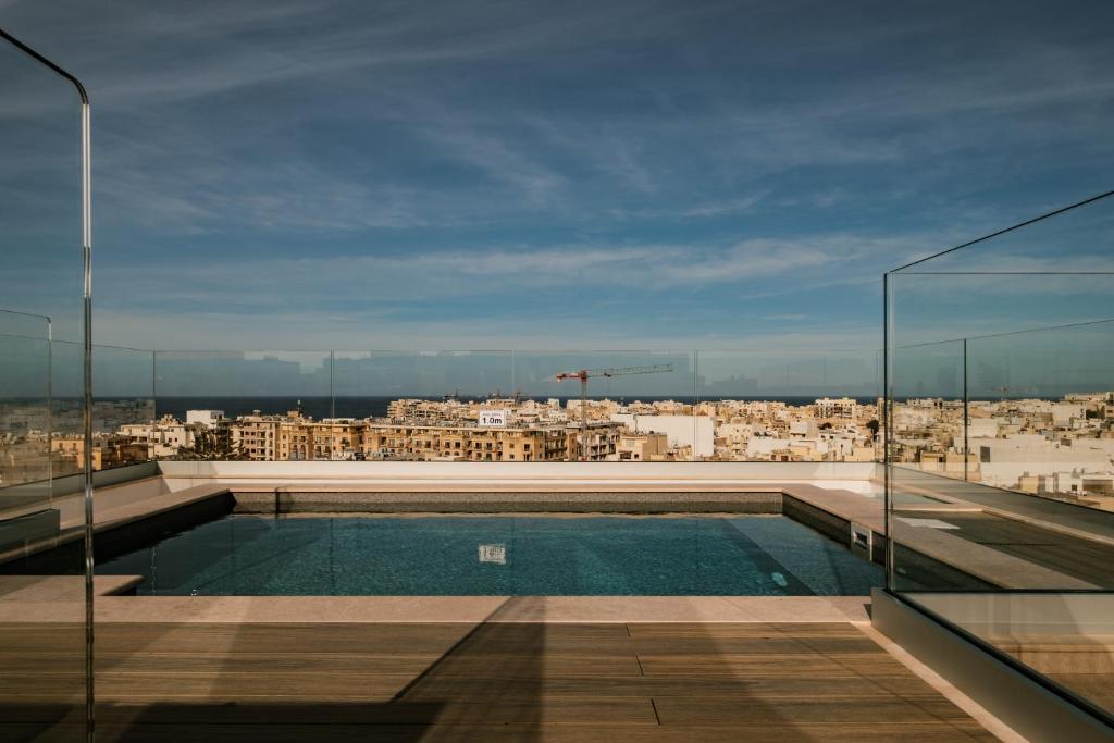 a swimming pool on the roof of a building at The Sliema Suites in Sliema