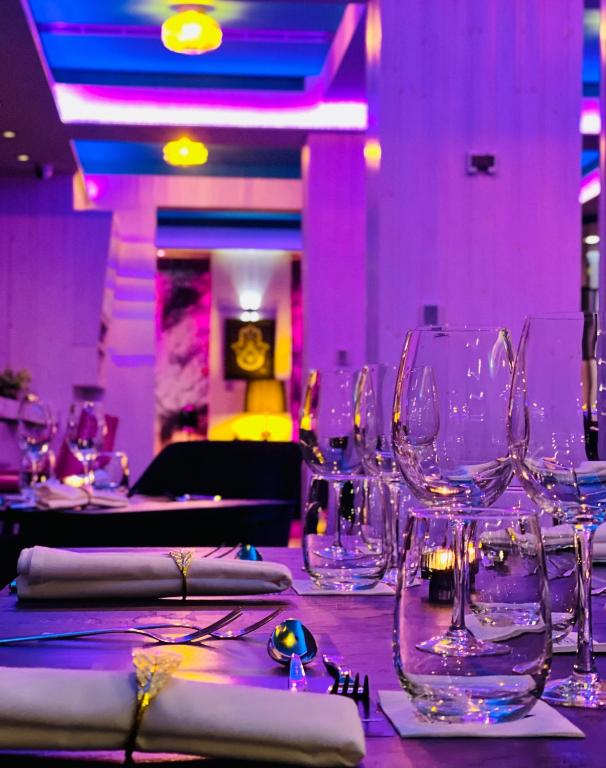 a table with empty wine glasses on it at The Ciao Stelio Deluxe Boutique Hotel - Adults Only in Larnaka