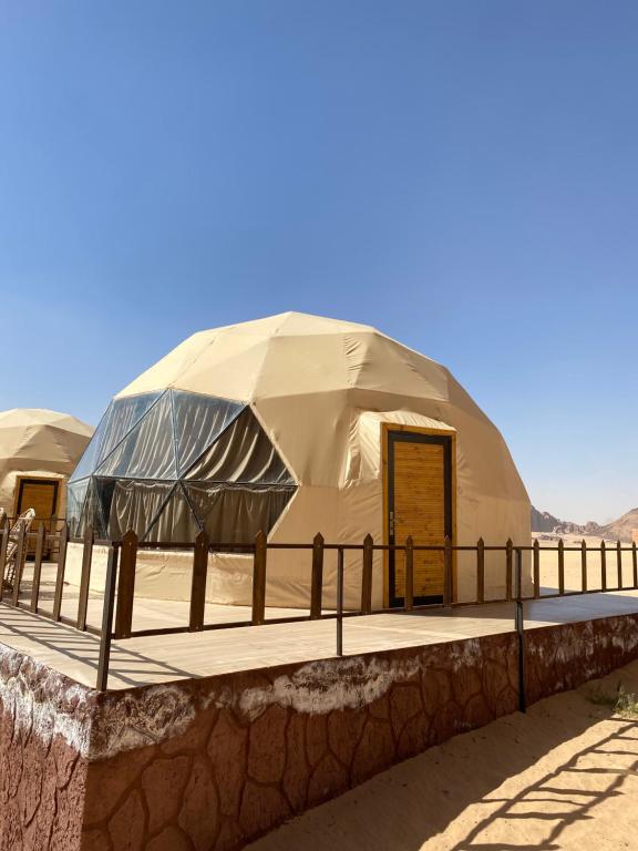 a large dome tent in the middle of the desert at Wadi Rum alsultan Camp in Wadi Rum