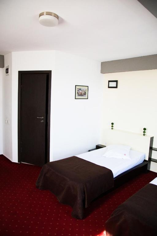 Postel nebo postele na pokoji v ubytování GP Hotel
