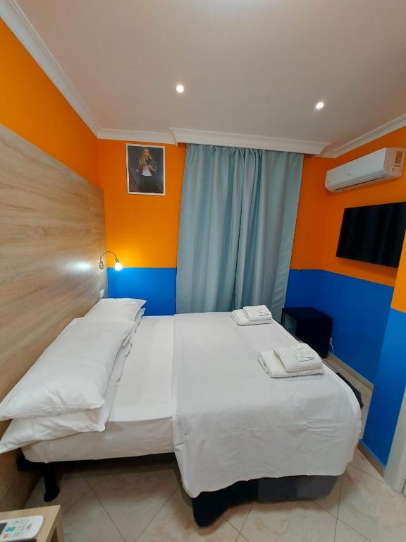 Postel nebo postele na pokoji v ubytování Hotel Positano