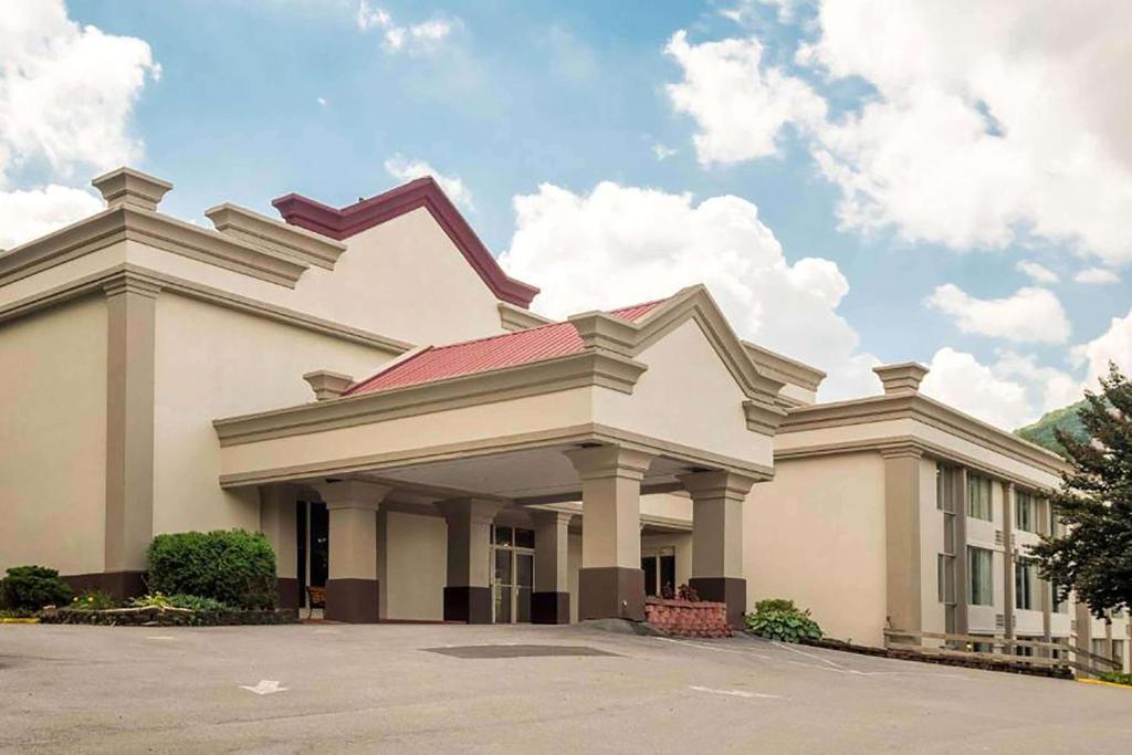 a large white building with a red roof at Days Inn by Wyndham Williamsport in Williamsport