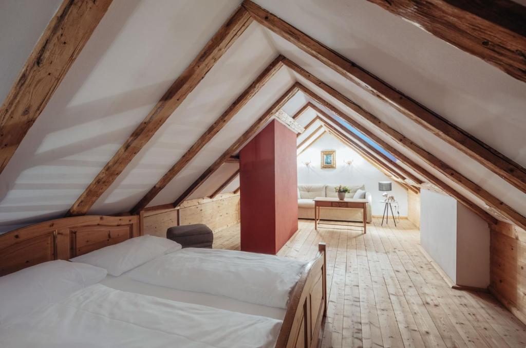 A bed or beds in a room at Romantik Spa Hotel Elixhauser Wirt