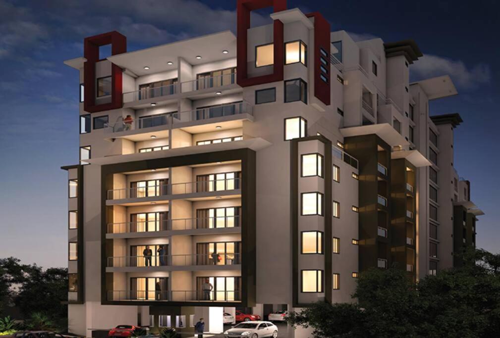 a large apartment building with lights on at Heaven Heights - Fully Furnished Air Con Apartment in Rose Hill