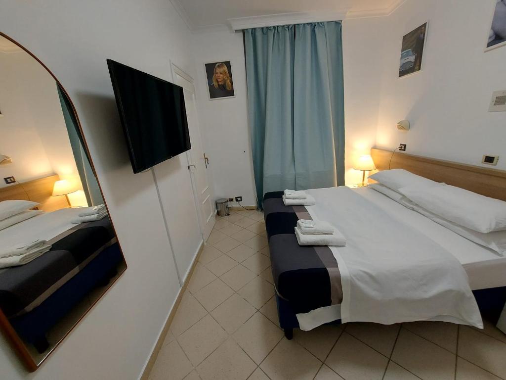 Postel nebo postele na pokoji v ubytování Hotel Positano