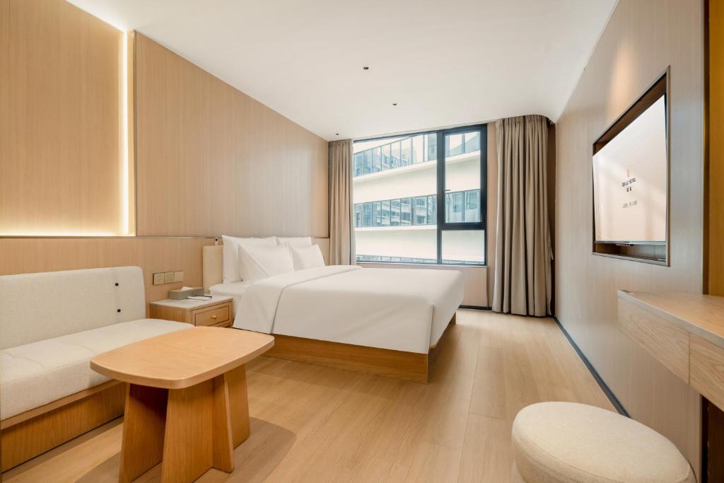 Postel nebo postele na pokoji v ubytování Relax Hotel - Shenzhen Bao'an International Airport