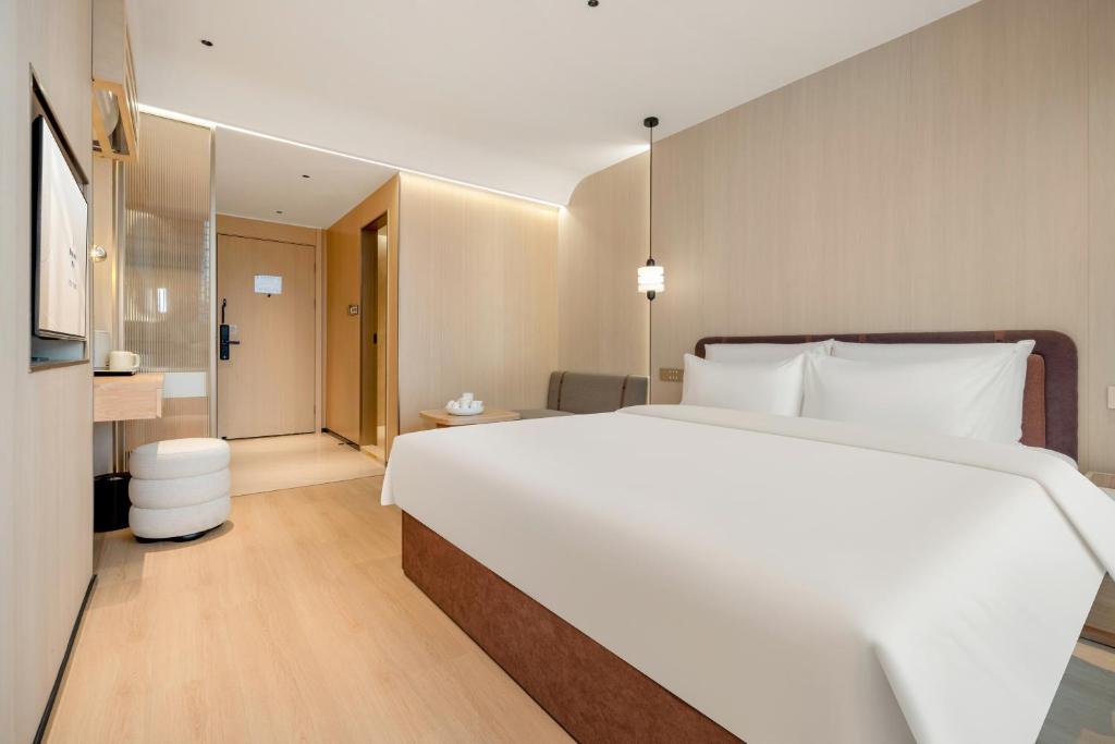 Postel nebo postele na pokoji v ubytování Relax Hotel - Shenzhen Bao'an International Airport