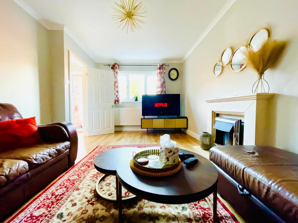 a living room with a couch and a table at Tanglewood Close, 3 Bedroom house, Abergavenny with private parking, in Abergavenny