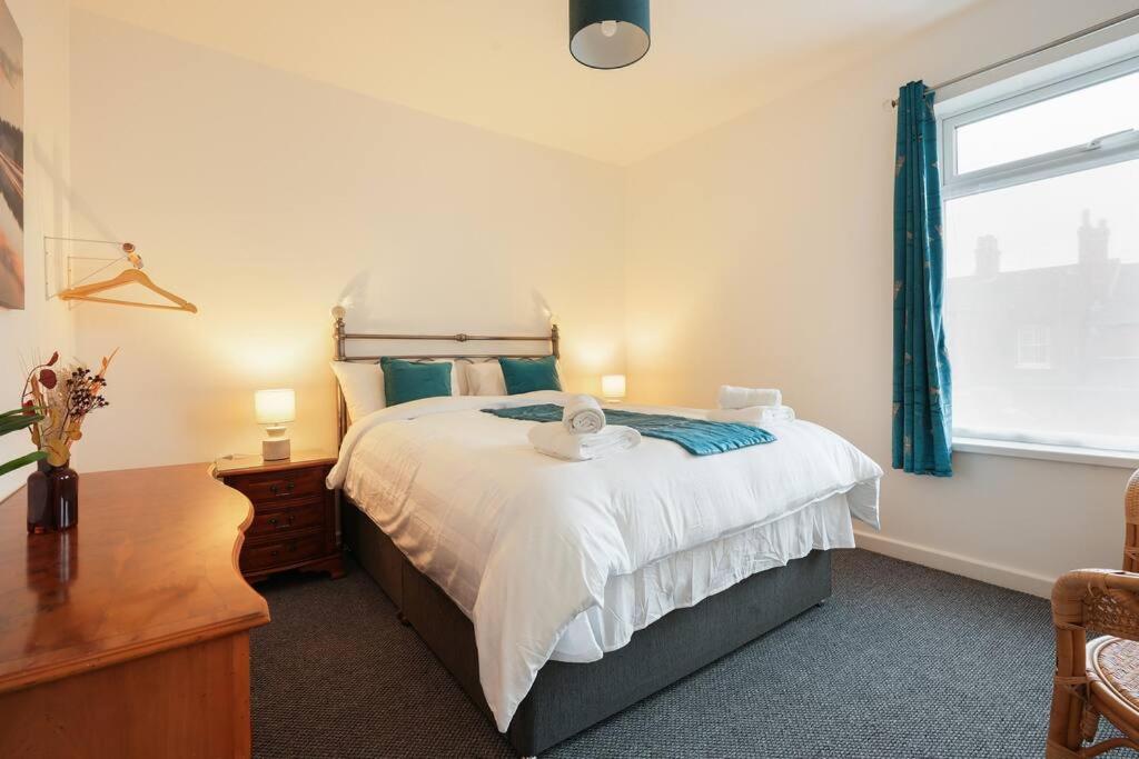 a bedroom with a large bed and a window at Grimsby City Centre stay in Grimsby