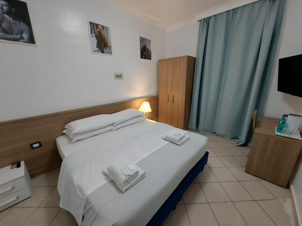 Postel nebo postele na pokoji v ubytování Hotel Positano