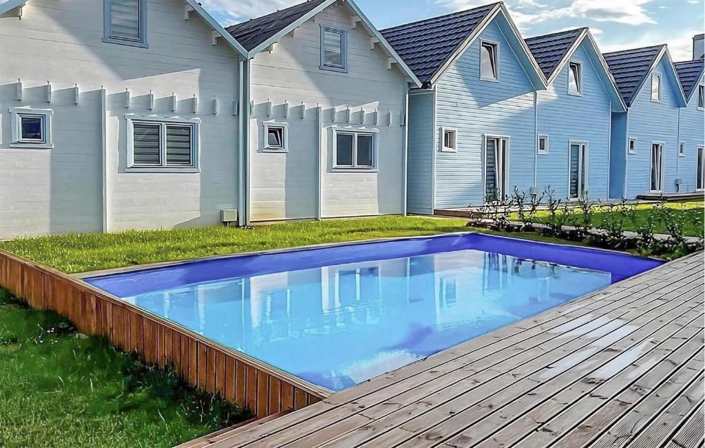a swimming pool in front of a house at Gorgeous Home In Rewal With Outdoor Swimming Pool in Rewal