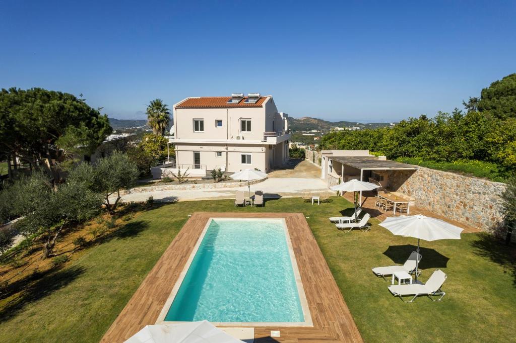 an external view of a villa with a swimming pool at Villa Adam in Chania Town