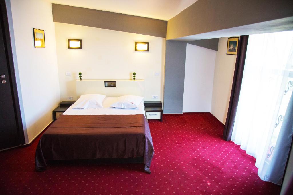 Postel nebo postele na pokoji v ubytování GP Hotel