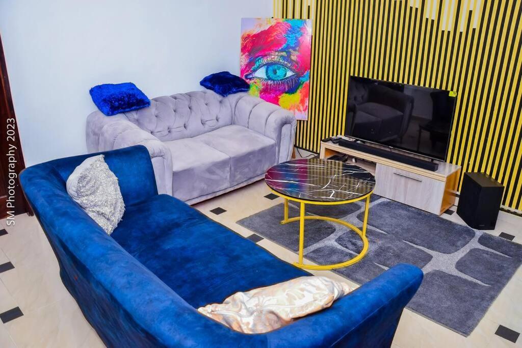 a living room with a couch and a table at Sweet and cozy in Cotonou