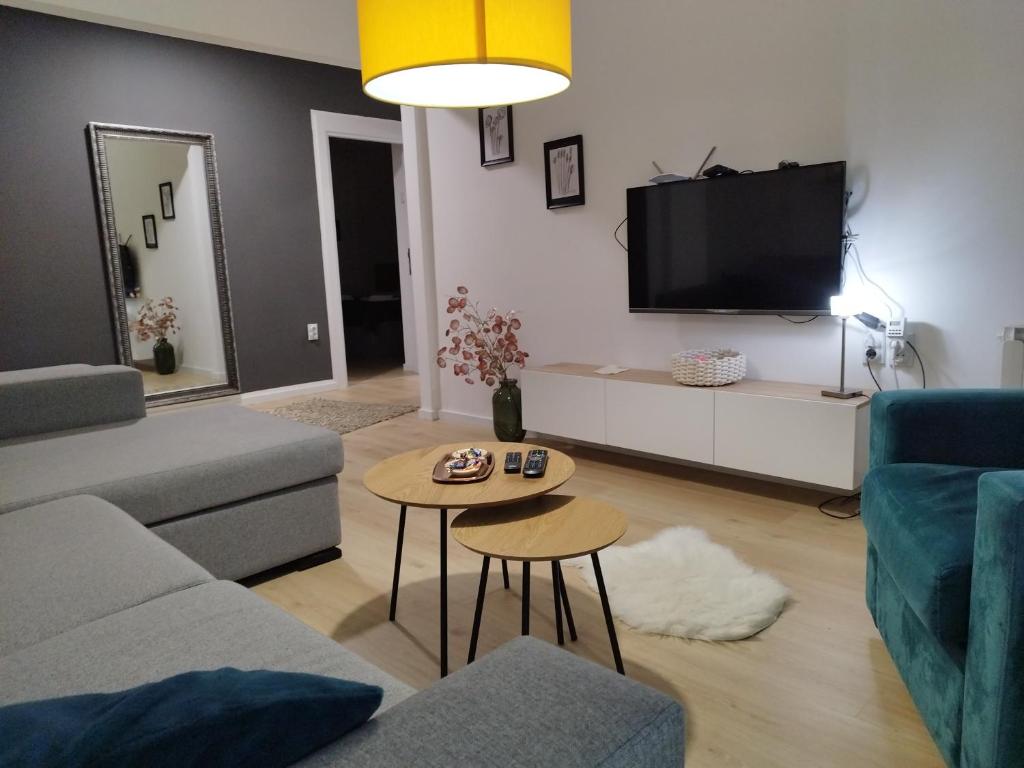 a living room with a couch and a table at Home apartment in Niš