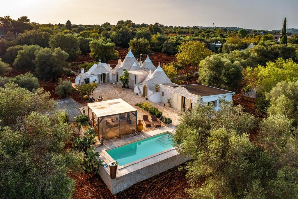 an aerial view of a house with a swimming pool at Trulli Magalò in Ceglie Messapica