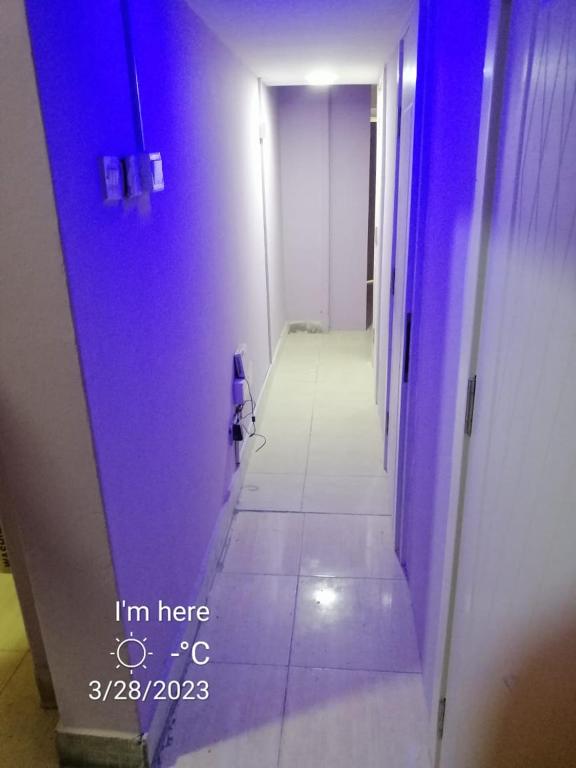 a hallway with a blue light in a room at Partition available 2 minutes away from Rigga metro Asians Only in Dubai