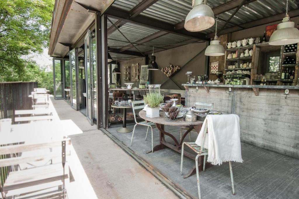 an outdoor patio with a table and chairs at Bassiviere Barn Chic in Saint-Étienne-de-Villeréal