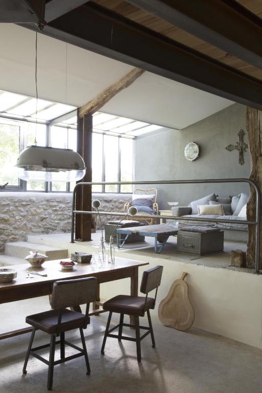 a living room with a table and chairs and a couch at Bassiviere Barn Chic in Saint-Étienne-de-Villeréal