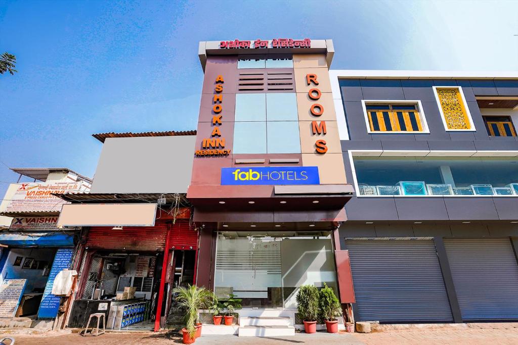 a building with a sign on the side of it at FabExpress Ashoka Inn - Nr Mumbai International Airport in Mumbai