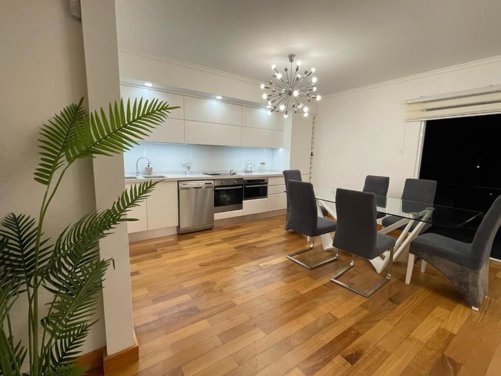 a kitchen and dining room with a table and chairs at NICE and MODERN FLAT NEAR AIRPORT in Santa Cruz