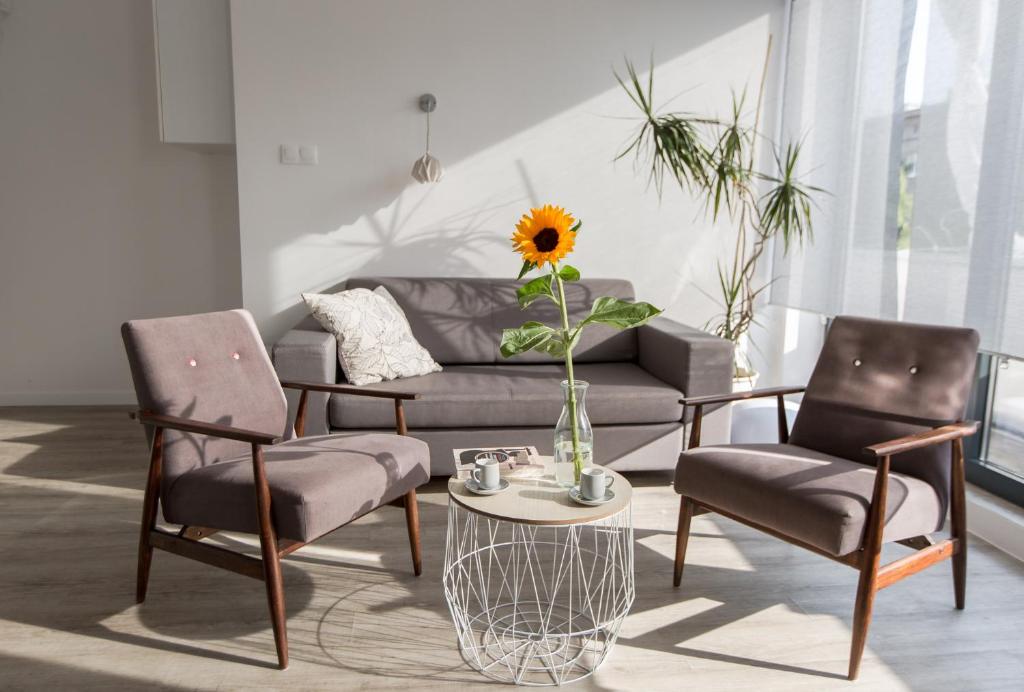 a living room with a couch and two chairs and a table at Sunny Mokotow - apartment near the metro in Warsaw