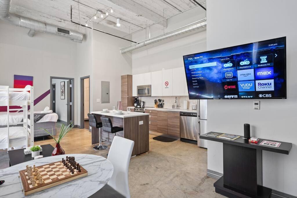 a room with a chess board on a table and a tv at Luxurious Downtown Apt - Pool, Laundry, Parking in Dallas