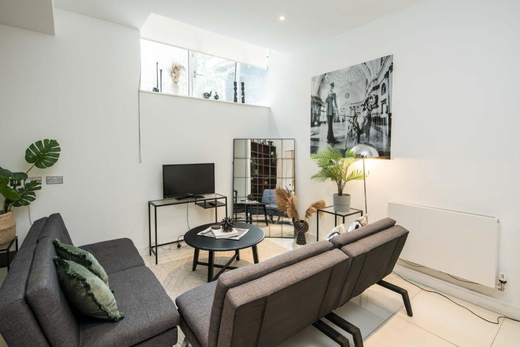 a living room with a couch and a table at Central-family-convenient-soho in London