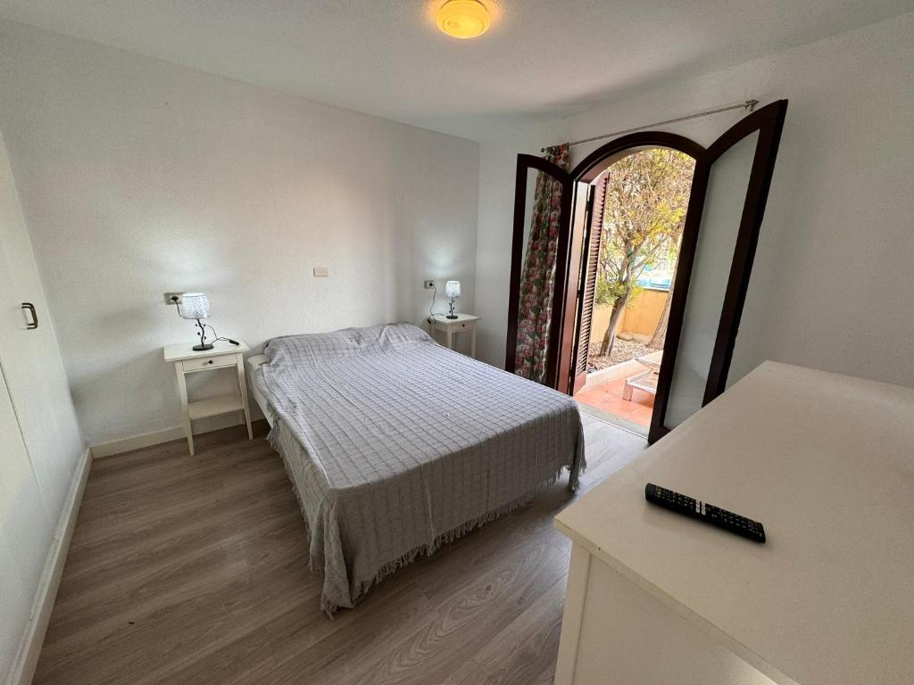a bedroom with a bed and a large window at Alquilaencanarias Tagoro Paradise in Costa Del Silencio