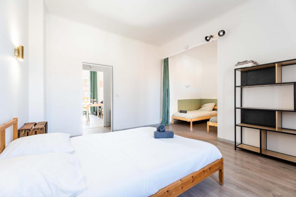 a bedroom with two beds and a living room at Grand appartement Familiale - Camargue in Salin-de-Giraud