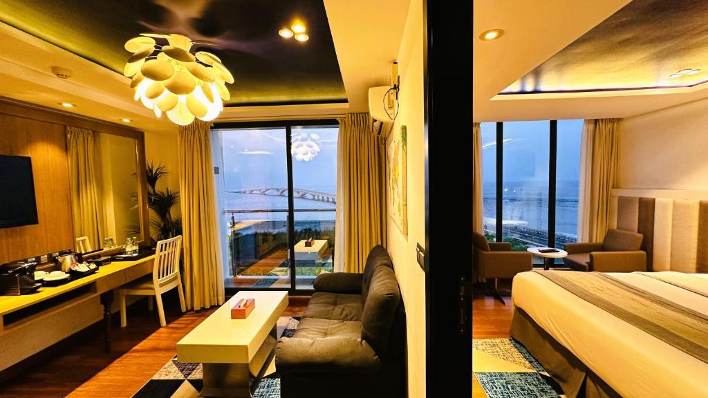 a hotel room with a bed and a view of the ocean at Beehive Premier in Male City