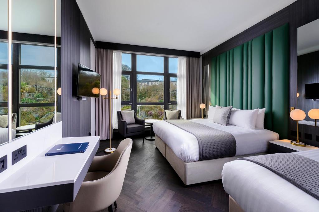 a hotel room with two beds and a television at Kinsale Hotel & Spa in Kinsale