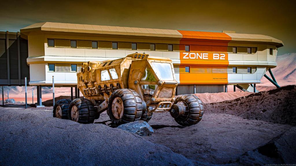 a dump truck parked in front of a building at Hôtel Station Cosmos in Chasseneuil-du-Poitou