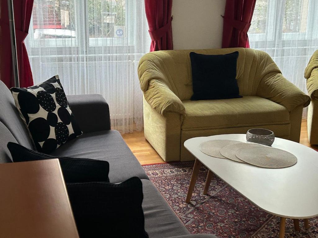 a living room with a couch and a coffee table at Apartment Sadova in Karlovy Vary