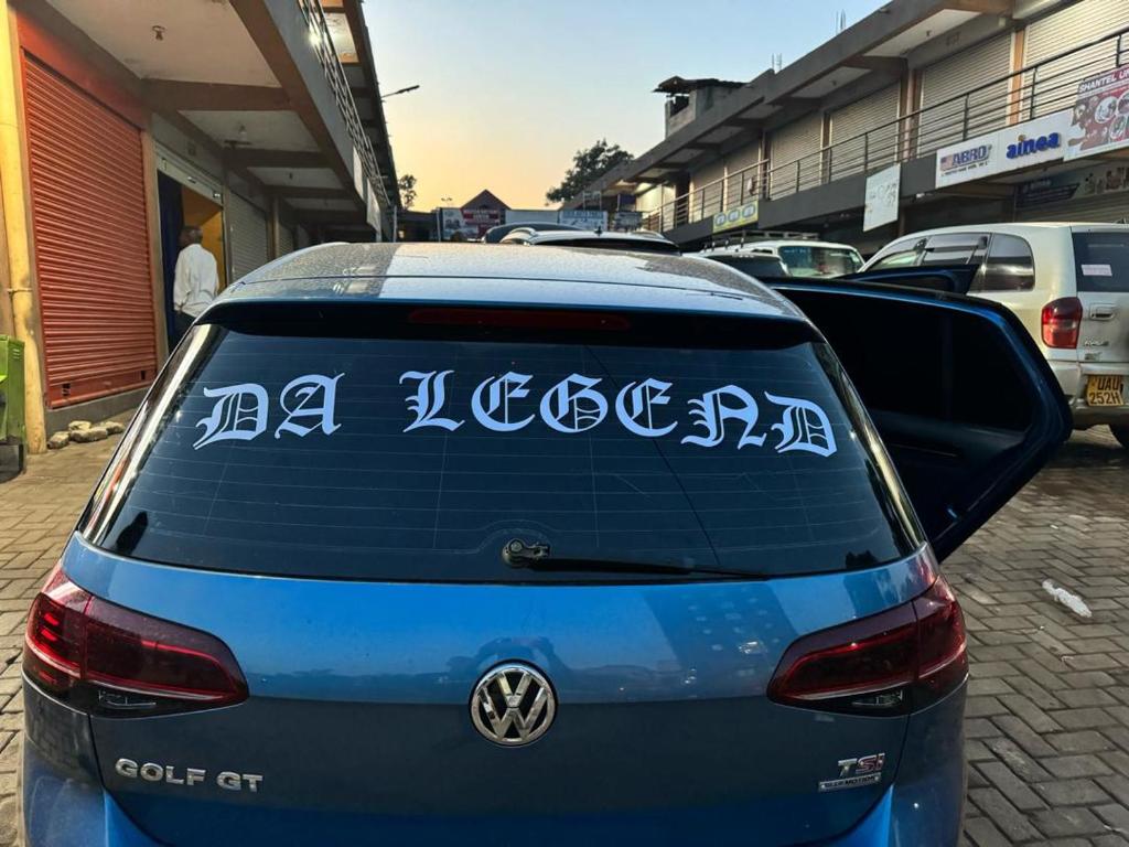 a blue car with writing on the back of it at DA LEGEND GUEST HOUSE BWEYALE in Kampala