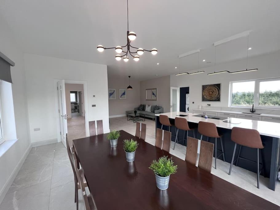 a kitchen and dining room with a table and chairs at Modern Dunboyne Home in Dunboyne