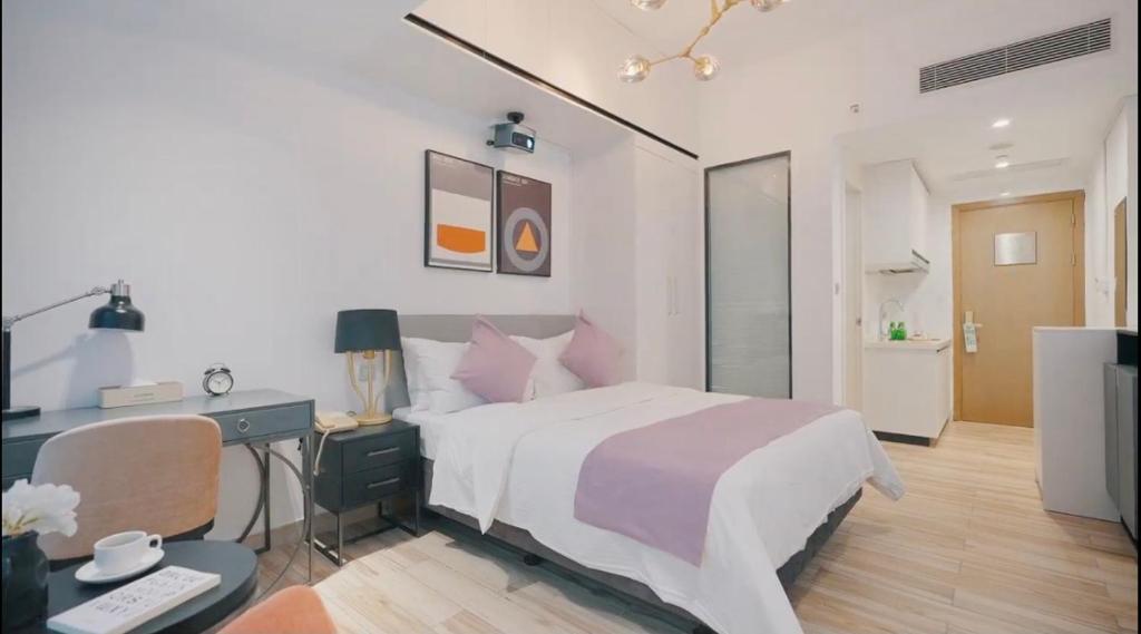 Postel nebo postele na pokoji v ubytování Golden Central Hotel Serviced Residence-Xin Hao E Du金中环服务公寓新浩e都店