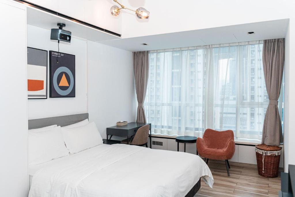 Postel nebo postele na pokoji v ubytování Golden Central Hotel Serviced Residence-Xin Hao E Du金中环服务公寓新浩e都店