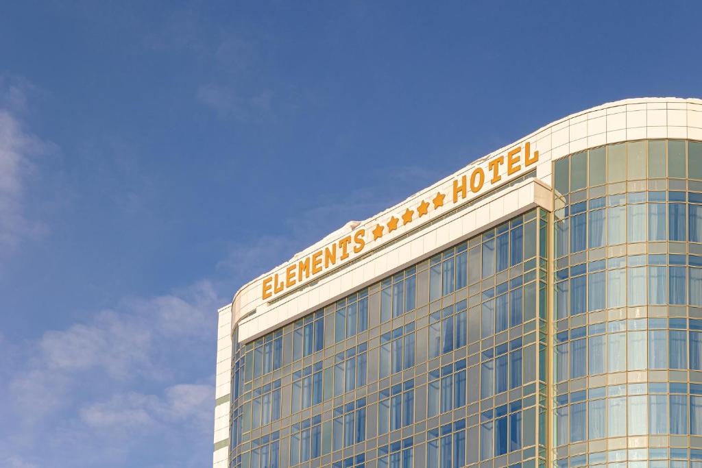 a building with a sign on the top of it at Elements Kirov Hotel in Kirov