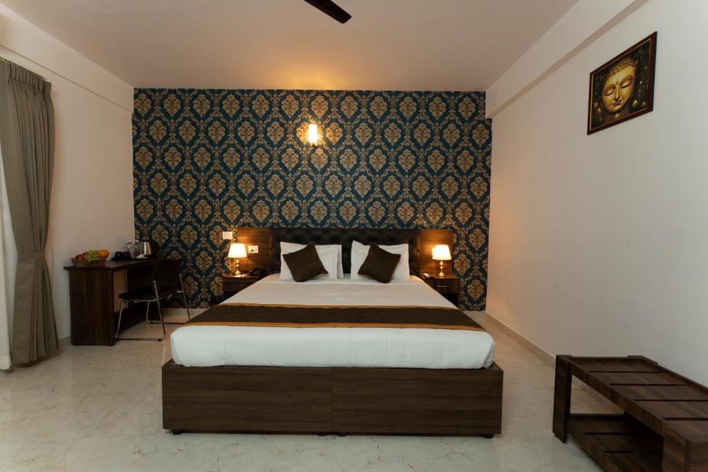 a bedroom with a large bed in a room at Sai Bliss International, Bangalore in Bangalore