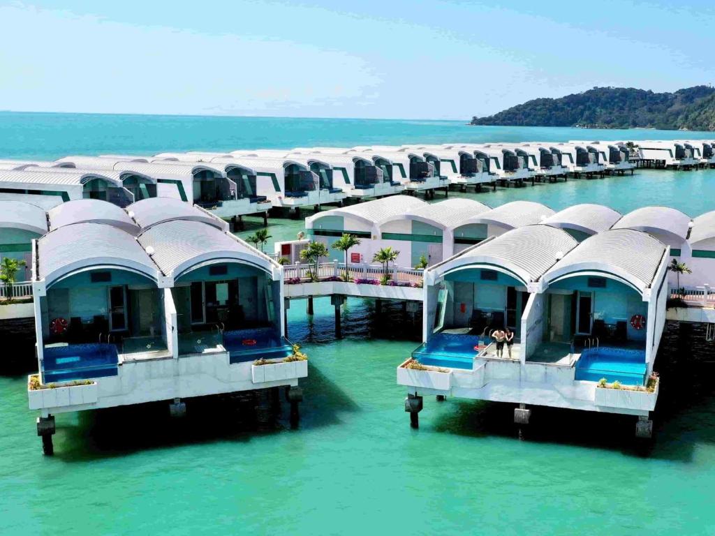 a row of houses on the water in the ocean at Port Dickson Leisure Water Villa in Port Dickson