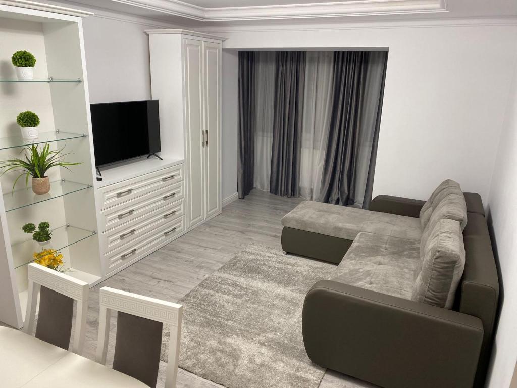 a living room with a couch and a television at Apartament Areni Suceava in Suceava