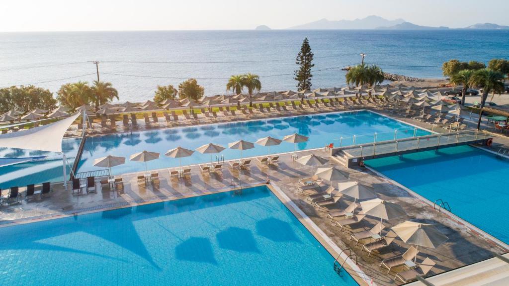 an overhead view of a pool with chairs and the ocean at Atlantica Mikri Poli Kos in Kardamaina