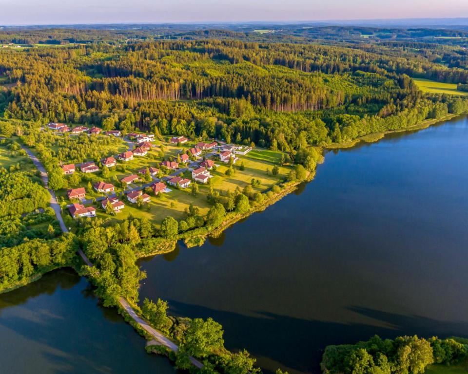 an aerial view of a resort on the shore of a lake at Amenity Resort Česká Kanada in Nová Bystřice