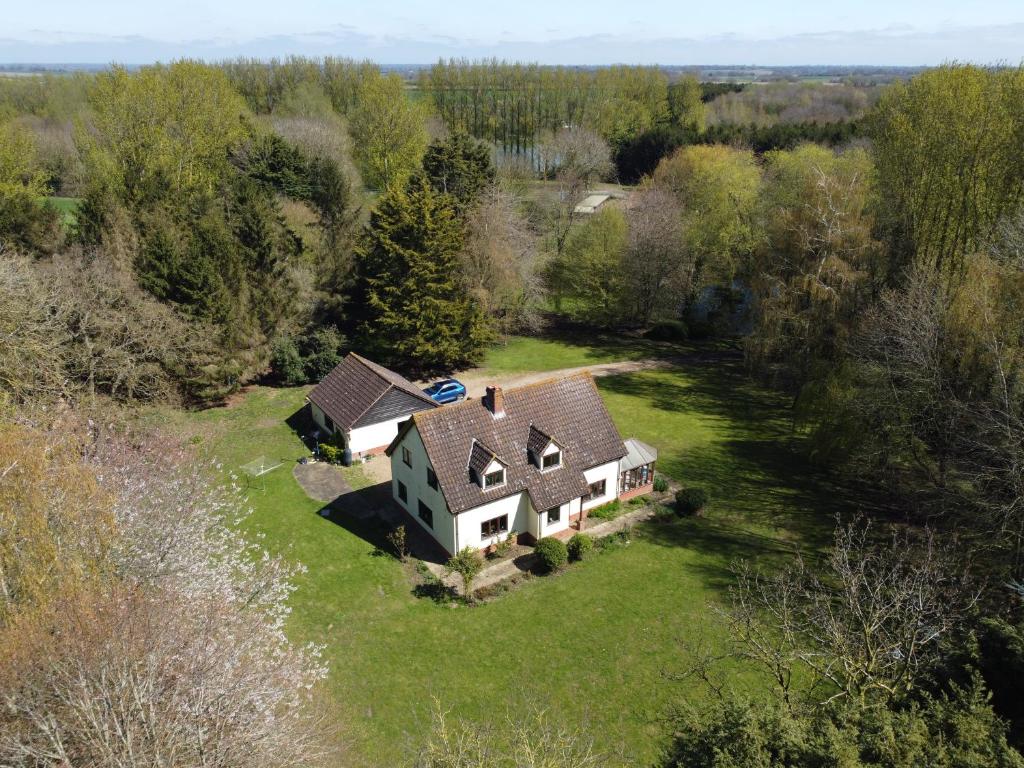an aerial view of a house on a green field at Rivendell in Diss