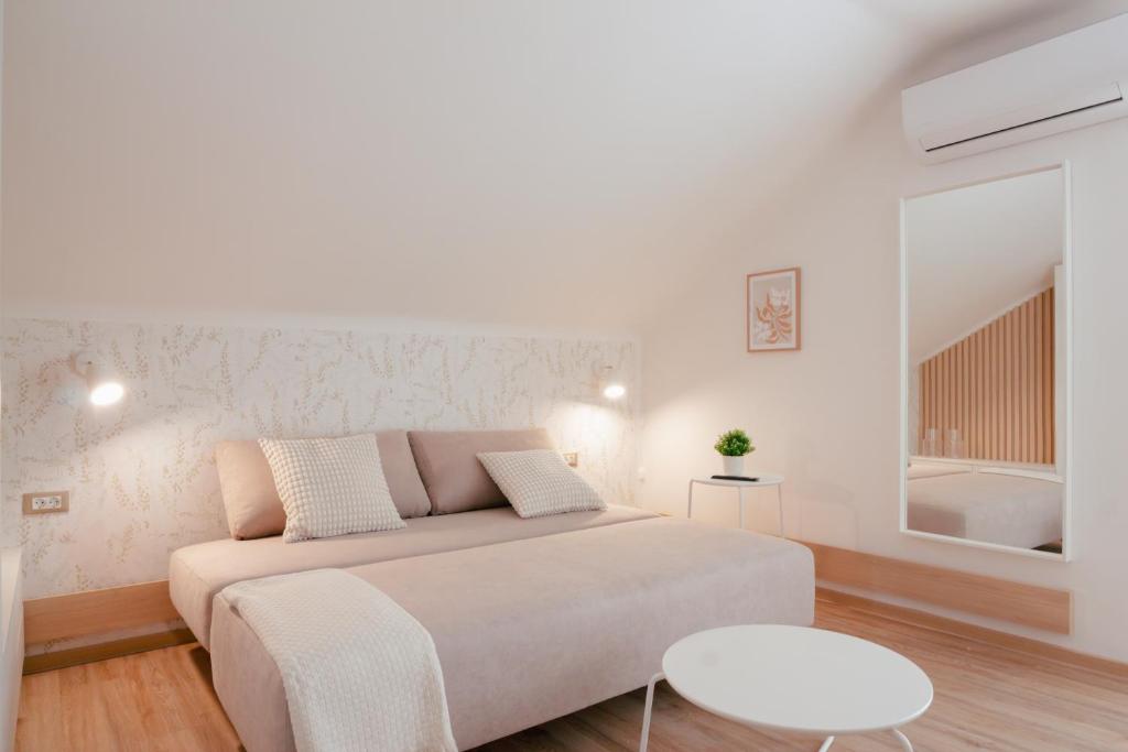 um quarto branco com uma cama e uma mesa em Luxury 2 bedroom NEW apartment with private parking em Ljubljana