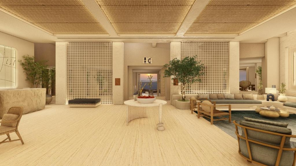 Grikos的住宿－Patmos Aktis Resort & Spa，客厅配有沙发和桌子