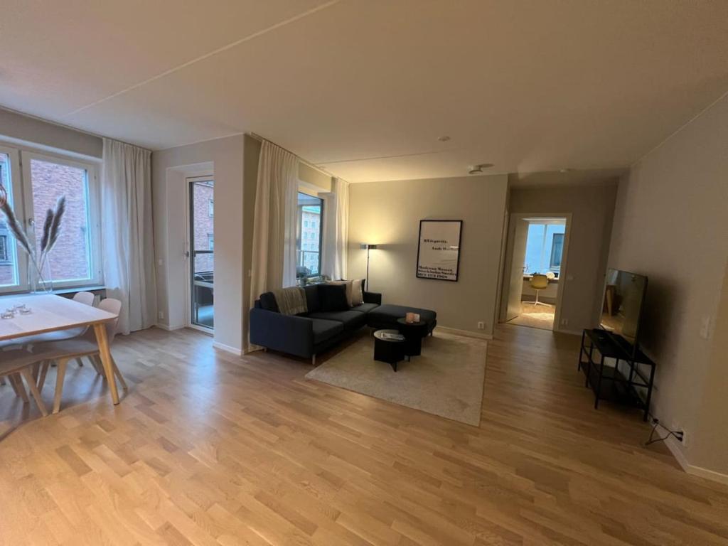 a living room with a couch and a table at New apartment in Hagastaden in Stockholm