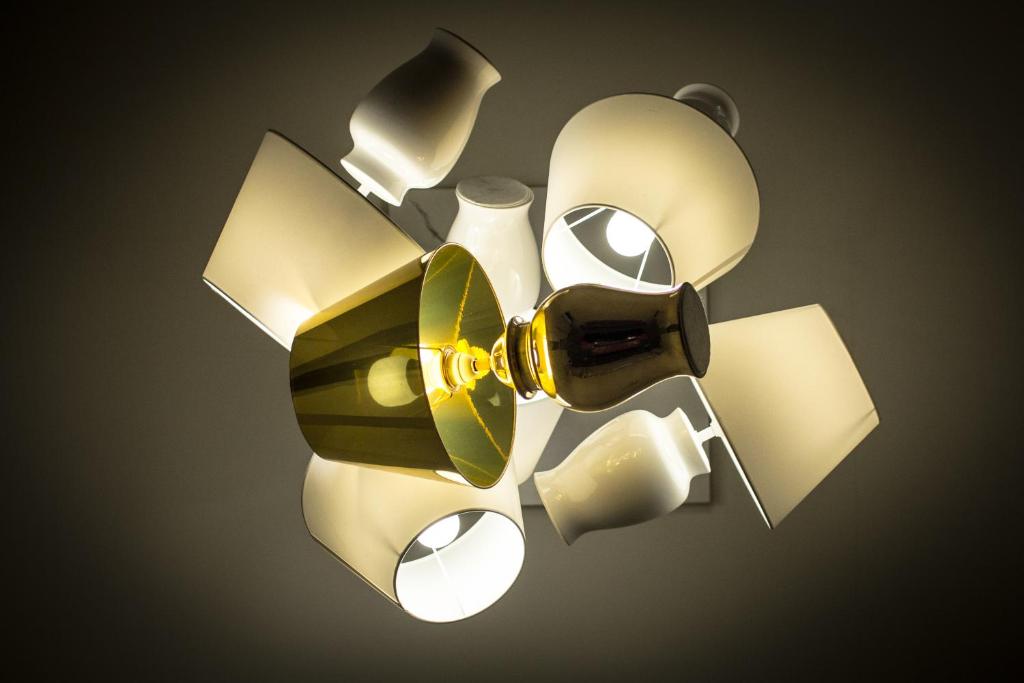 a ceiling light with a bunch of objects on it at Hotel Universal in Livorno