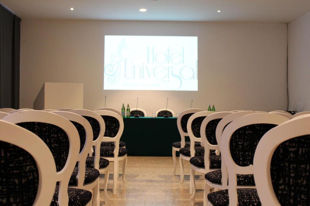 a row of chairs in a room with a screen at Hotel Universal in Livorno